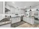 Open kitchen with white cabinets, stainless appliances and view into the living area at 1919 Laurel St, Sarasota, FL 34236