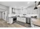 Bright kitchen features stainless appliances, grey countertops, white cabinets, and a tile backsplash at 1919 Laurel St, Sarasota, FL 34236