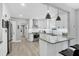 Beautiful kitchen featuring white cabinets, stainless steel appliances, and modern pendant lighting at 1919 Laurel St, Sarasota, FL 34236