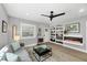 Living room features a large window, built-in shelving, modern ceiling fan and a comfortable sofa at 1919 Laurel St, Sarasota, FL 34236