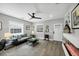 Cozy living room with a sofa, modern ceiling fan, large windows, and built-in shelving at 1919 Laurel St, Sarasota, FL 34236