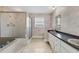 Functional bathroom with a shower and tub, a long vanity, and updated sink fixtures at 2002 8Th W St, Palmetto, FL 34221