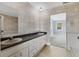 Functional bathroom featuring double sinks, a tiled floor, and a doorway to the bedroom at 2002 8Th W St, Palmetto, FL 34221