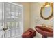 Unique powder room featuring a red sink and toilet, shuttered window, and gold mirror at 2002 8Th W St, Palmetto, FL 34221
