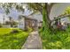 Charming home with a lush lawn, a sunroom, and walkway leading to a pool at 2002 8Th W St, Palmetto, FL 34221