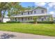 Inviting home showcasing a charming wrap-around porch and a well-maintained lawn at 2002 8Th W St, Palmetto, FL 34221