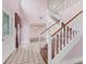 A grand foyer with high ceilings, tile flooring, and a beautiful staircase, creating a welcoming entrance at 2002 8Th W St, Palmetto, FL 34221