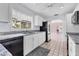 Updated kitchen with white cabinets, granite countertops, stainless appliances, and open layout at 2002 8Th W St, Palmetto, FL 34221