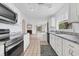 Updated kitchen with white cabinets, granite countertops, and stainless steel appliances at 2002 8Th W St, Palmetto, FL 34221