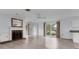 Bright living room featuring a fireplace, neutral paint, hardwood floors and large windows at 2002 8Th W St, Palmetto, FL 34221