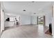 Open-concept living room featuring hardwood floors, ample natural light, and adjacent kitchen at 2002 8Th W St, Palmetto, FL 34221