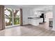Open-concept living room featuring hardwood floors, ample natural light, and adjacent kitchen at 2002 8Th W St, Palmetto, FL 34221