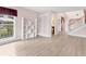 A bright and airy living room with lots of natural light, plenty of open space, and wood laminate floors at 2002 8Th W St, Palmetto, FL 34221