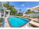 Beautiful backyard with a pool, lounge chairs, and a view of the boat lift on the canal at 2002 8Th W St, Palmetto, FL 34221
