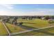 Scenic property with verdant pastures, mature trees, white equestrian fencing, a serene pond, and a charming barn at 20504 65Th E Ave, Bradenton, FL 34211