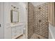 Elegant bathroom features a walk-in shower with custom tile and a vanity with marble countertop at 20504 65Th E Ave, Bradenton, FL 34211
