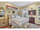 Inviting bedroom with neutral walls, upholstered headboard, ornate mirror, and plush bedding at 20504 65Th E Ave, Bradenton, FL 34211