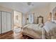 Cozy bedroom features a bed with white bedding, wood floors, and natural light from the window at 20504 65Th E Ave, Bradenton, FL 34211