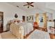 Tranquil bedroom boasts a luxurious bed, hardwood floors, area rug, and bright window at 20504 65Th E Ave, Bradenton, FL 34211