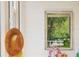 Close-up of screened porch with a framed mirror, an orchid and straw hat on a wall with white siding at 20504 65Th E Ave, Bradenton, FL 34211