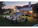 Backyard with pool and gazebo at dusk, with the large house in the background at 20504 65Th E Ave, Bradenton, FL 34211