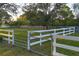 Spacious fenced yard with lush greenery, mature trees, and a secure gated entrance for added privacy and security at 20504 65Th E Ave, Bradenton, FL 34211