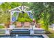 Backyard pool featuring a gazebo, a tiered water feature and lounge furniture for upscale outdoor living at 20504 65Th E Ave, Bradenton, FL 34211