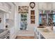 A kitchen features marble countertops, stainless appliances, a cooktop, and custom cabinets with decorative hardware at 20504 65Th E Ave, Bradenton, FL 34211