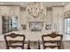 A kitchen features an island with stool seating, marble countertops, stainless appliances and custom cabinets at 20504 65Th E Ave, Bradenton, FL 34211