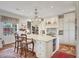 Elegant kitchen featuring a large island with seating, custom cabinetry, and a decorative chandelier at 20504 65Th E Ave, Bradenton, FL 34211