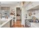 A kitchen features an island with marble countertops, stainless appliances and custom cabinets at 20504 65Th E Ave, Bradenton, FL 34211