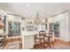 Spacious kitchen with custom cabinets, marble counters, an island, stainless appliances and a stunning chandelier at 20504 65Th E Ave, Bradenton, FL 34211