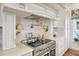 A kitchen features marble countertops, stainless appliances, a cooktop and custom cabinets at 20504 65Th E Ave, Bradenton, FL 34211