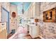 Bright laundry room showcasing ample white cabinetry with gold trim, decorative wallpaper, and unique blue ceiling at 20504 65Th E Ave, Bradenton, FL 34211
