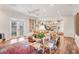 Bright and airy living room with hardwood floors, chandelier, and French doors leading to the outside at 20504 65Th E Ave, Bradenton, FL 34211