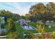 Aerial view of a private backyard featuring a rectangular pool with a gazebo and lounge area, surrounded by lush greenery at 20504 65Th E Ave, Bradenton, FL 34211