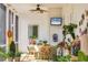 Inviting screened porch decorated with plants, wicker furniture, and a ceiling fan for relaxed outdoor living at 20504 65Th E Ave, Bradenton, FL 34211