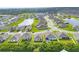 Beautiful aerial shot of a residential community with well-maintained lawns and serene pond views at 2105 Grand Flora Trl, Bradenton, FL 34208