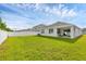 Spacious backyard featuring a well-maintained lawn and a white fence at 2105 Grand Flora Trl, Bradenton, FL 34208