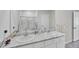 Bright bathroom featuring double sink vanity with white cabinets and elegant marble countertop at 2105 Grand Flora Trl, Bradenton, FL 34208