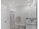 Bathroom with double sinks, white marble counters, grey tile floor, shower with decorative white and gold curtains at 2105 Grand Flora Trl, Bradenton, FL 34208