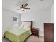 Cozy bedroom with neutral colors, a ceiling fan, and ample natural light at 2105 Grand Flora Trl, Bradenton, FL 34208