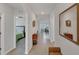Bright hallway with decorative mirror leading to the bedroom, living, and dining area at 2105 Grand Flora Trl, Bradenton, FL 34208