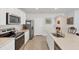 Well-equipped kitchen features modern appliances, white cabinetry, and countertops at 2105 Grand Flora Trl, Bradenton, FL 34208