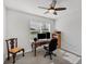 Well-lit home office with a ceiling fan and a large window creating a comfortable workspace at 2105 Grand Flora Trl, Bradenton, FL 34208