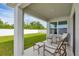 Relaxing covered patio with seating overlooking the fenced backyard at 2105 Grand Flora Trl, Bradenton, FL 34208