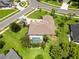 Aerial view of a home with a screened pool, spacious yard, and well-manicured landscaping at 2199 Palm Ct, North Port, FL 34287