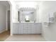 Bathroom with a double sink vanity with large mirror at 2199 Palm Ct, North Port, FL 34287