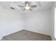 A bright bedroom features neutral carpet, white walls, a ceiling fan, and a window at 2199 Palm Ct, North Port, FL 34287