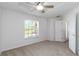 Bright bedroom featuring a ceiling fan, neutral carpet, and a large window offering natural light at 2199 Palm Ct, North Port, FL 34287